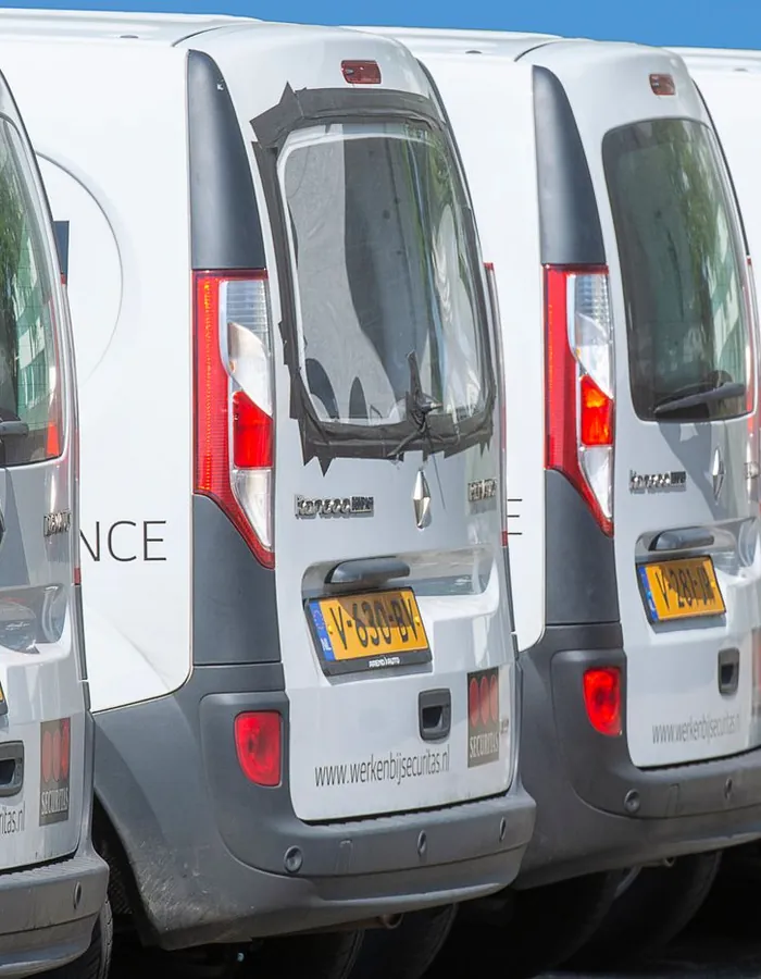 Stock photo: a row of parked white vans