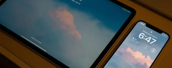 Stock photo: a tablet and smartphone on their lock screens